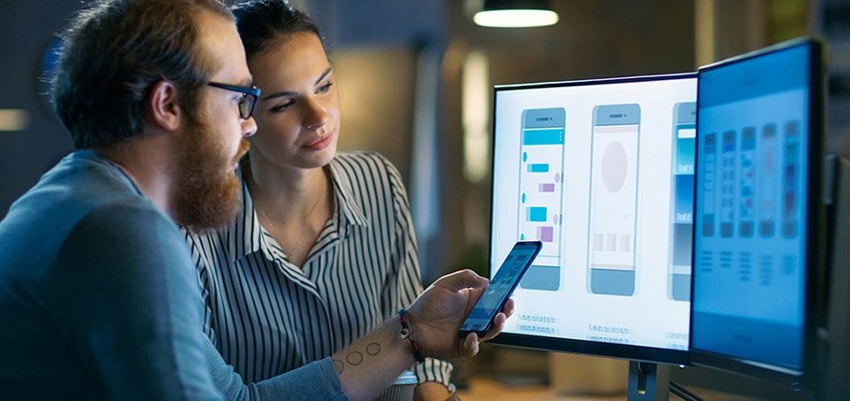 hybrid app developers reviewing design on screen