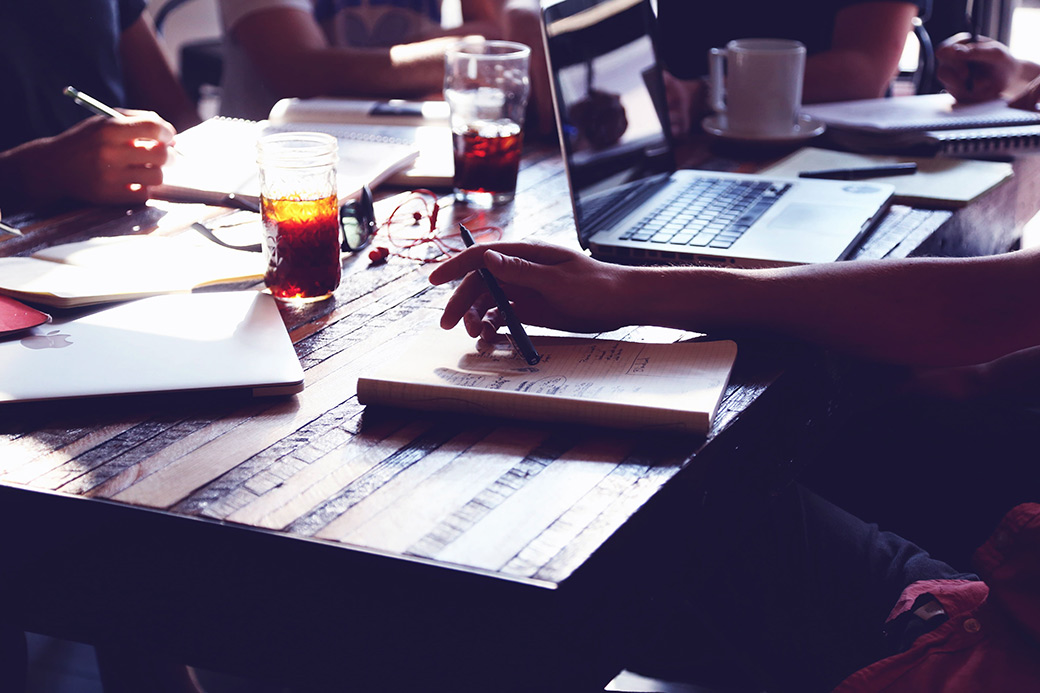 people around table working on custom software development solution